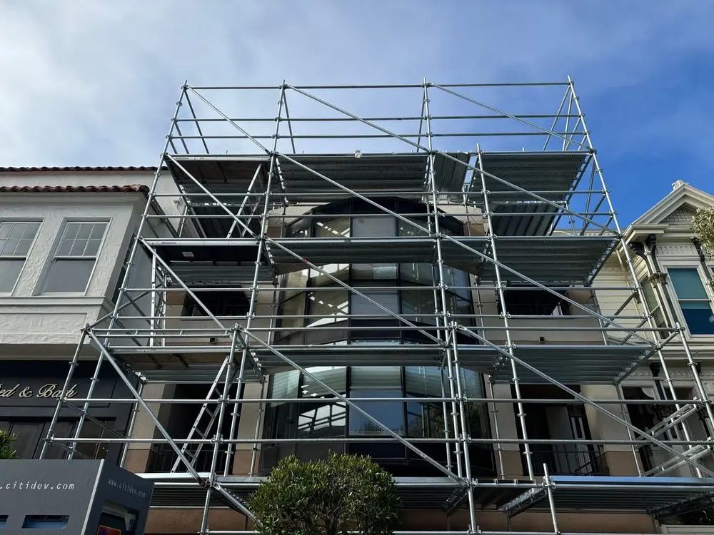 Multi-story hillside home surrounded by full scaffolding for exterior construction, Scaffolding San Francisco